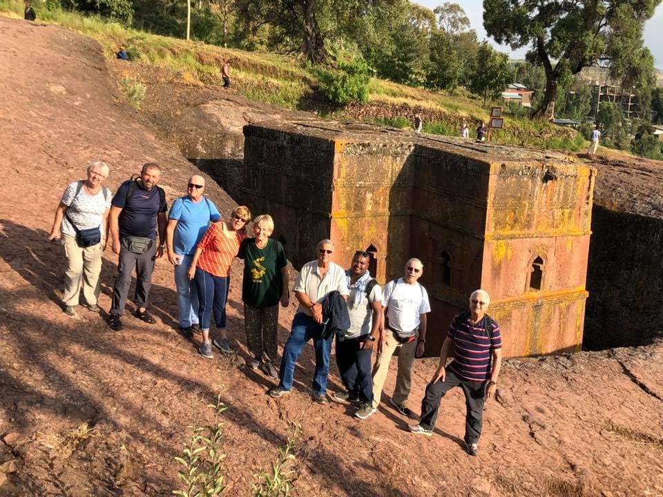 Group of tourists visiting the rock-hewn Church of Saint George in Lalibela